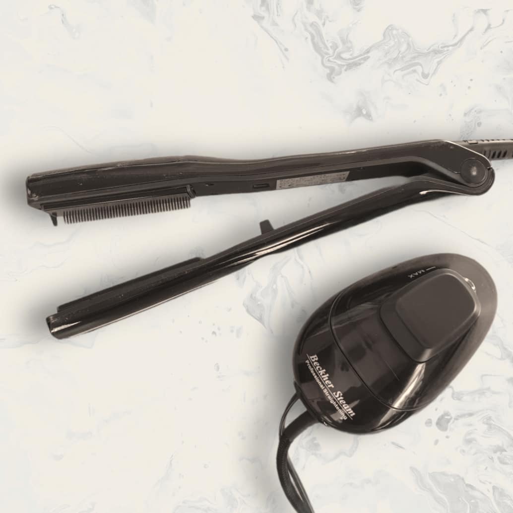 The Beckher Steam hair-straightening iron and its steam pod on a marble surface