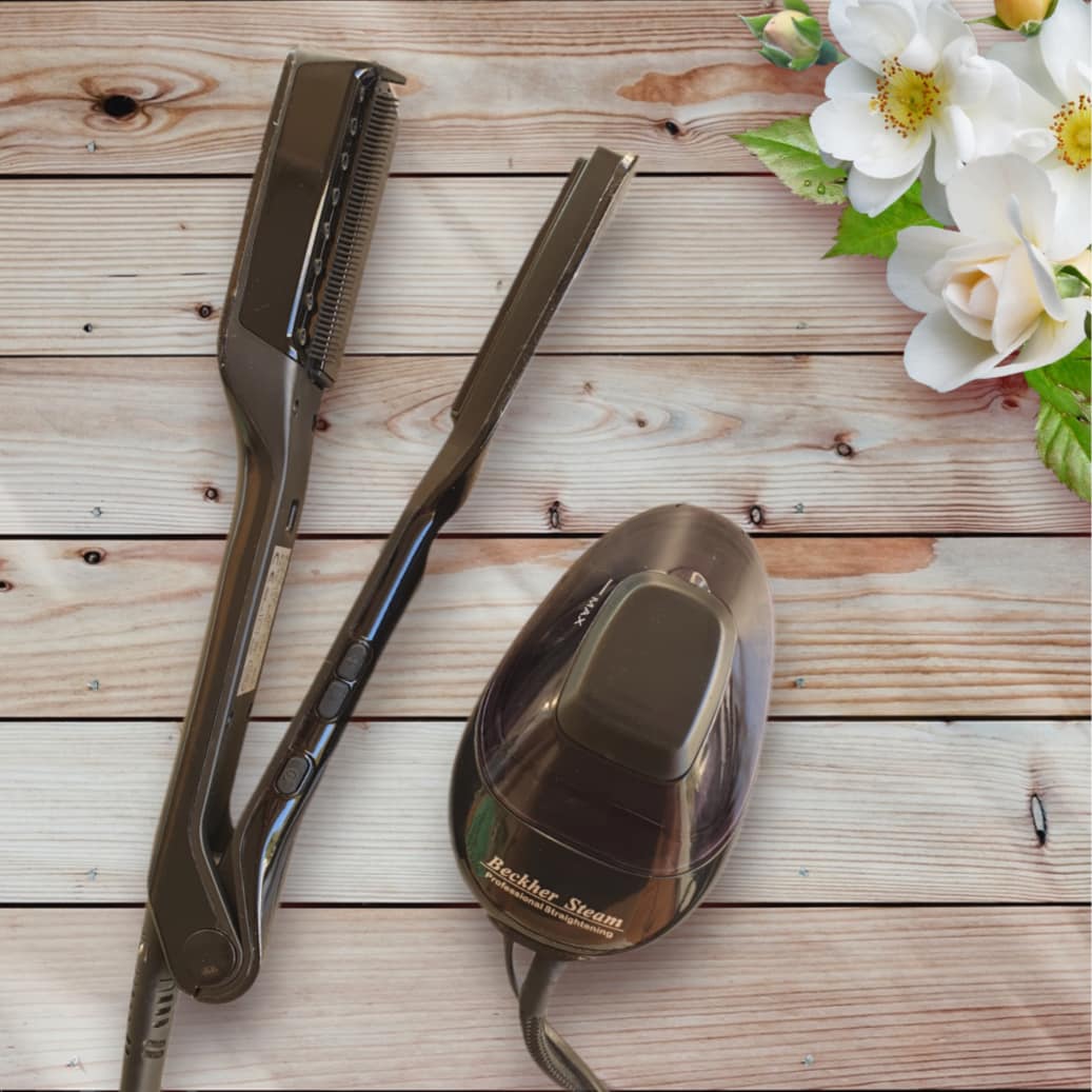 The Beckher Steam hair-straightening iron and its steam pod on a wooden table with some flowers